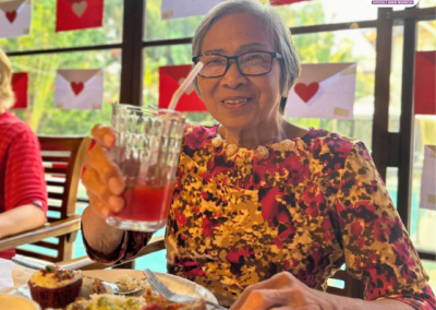 A Senior Enjoying A Special Meal During A Social Event